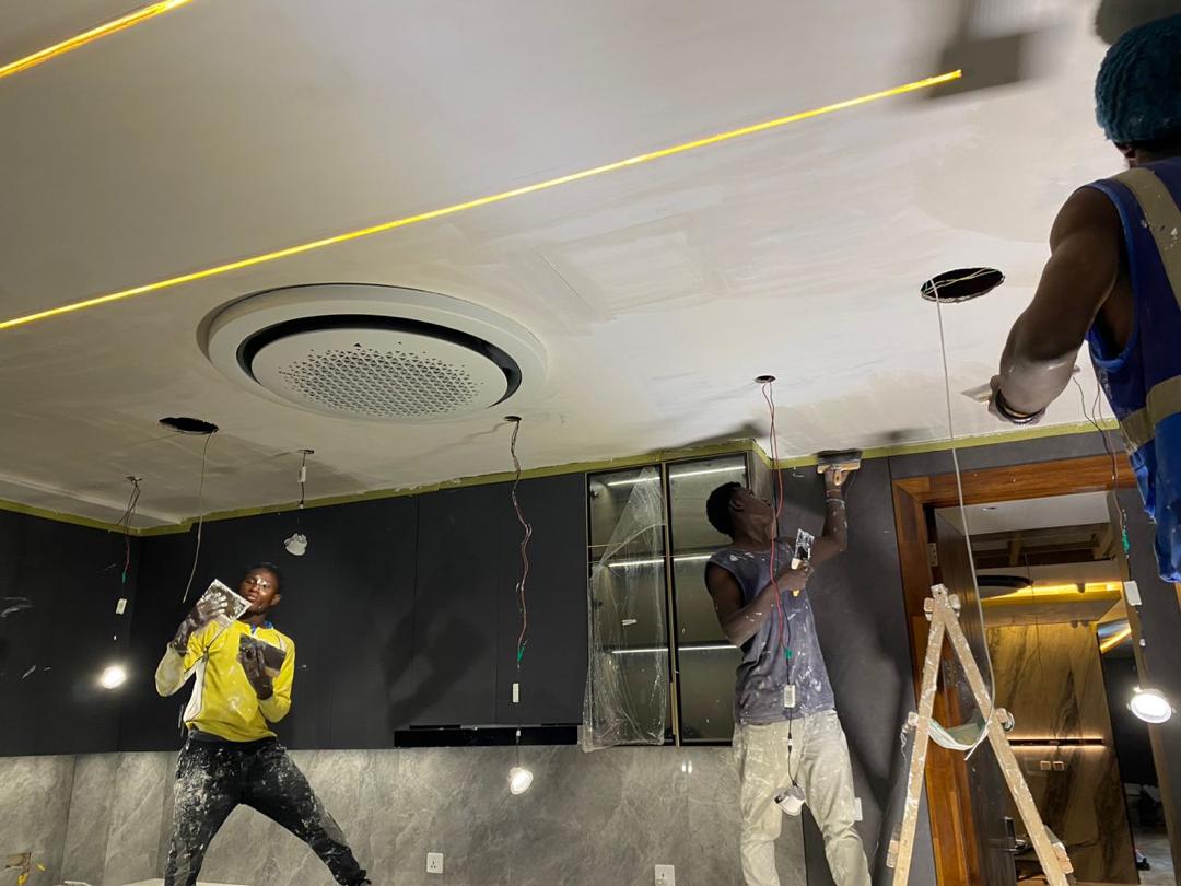 Paintboss worker applying ceiling finishing on site