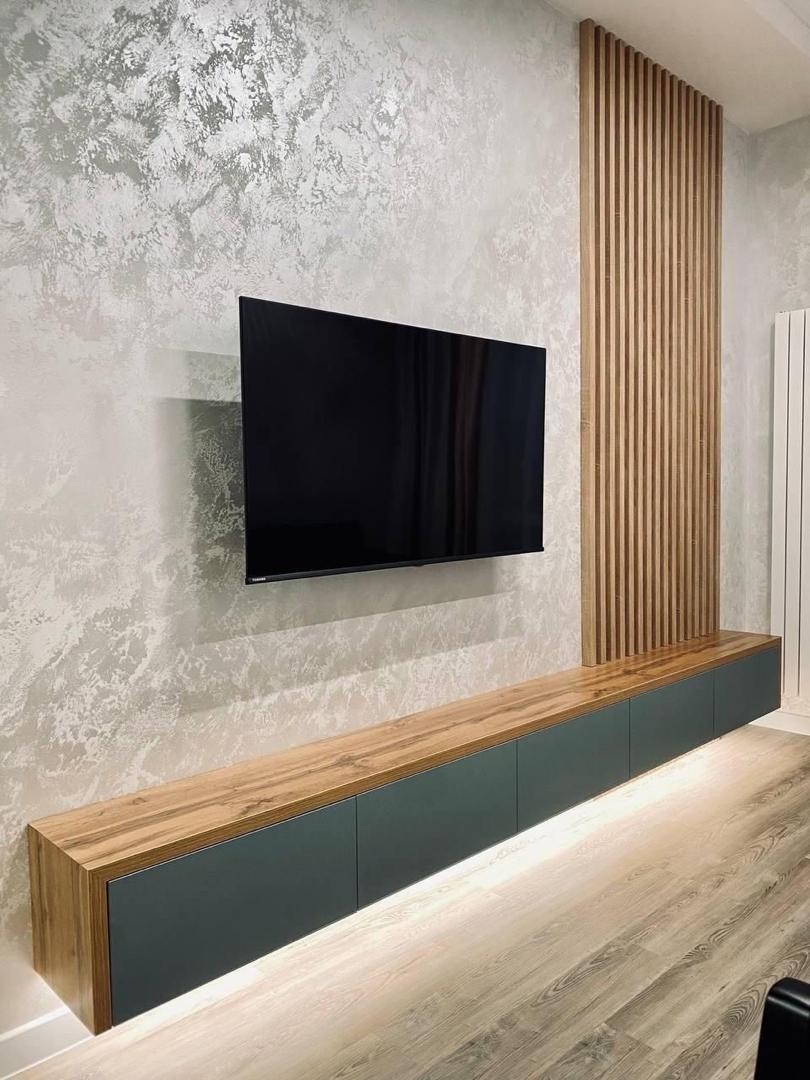 Decorative floating shelves with wood slats and marble effect wall