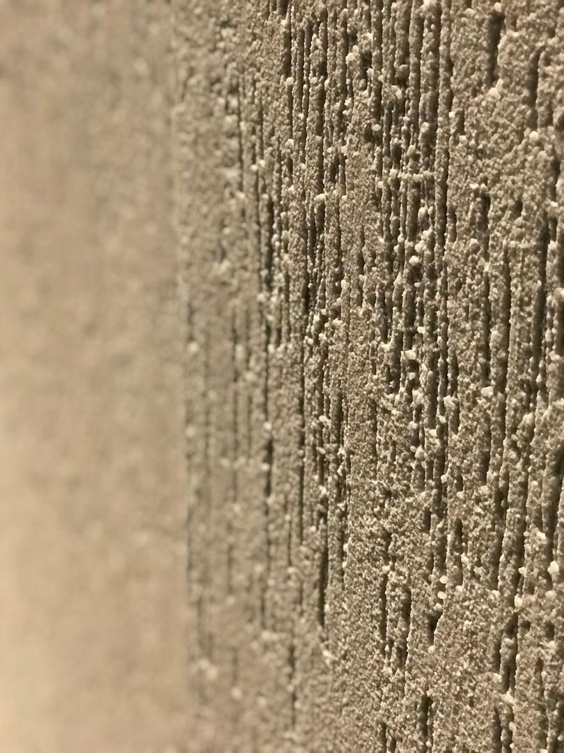 Fence and building perimeter with textured wainscoting finish